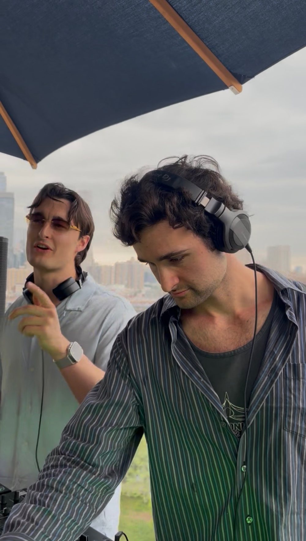PREWAR on the decks on a rooftop under an umbrella